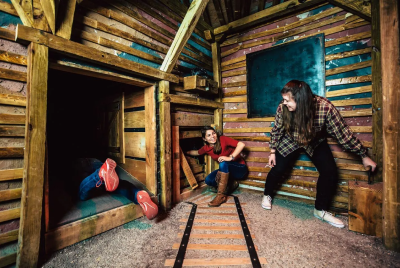 3 person looking for a way to exit form wooden room in a creepy jungle